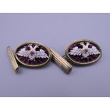 A pair of silver and enamel cufflinks, bearing Russian marks. Each 2.5 cm wide.