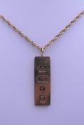 A 9 ct gold ingot on a 9 ct gold chain. 27.1 grammes.