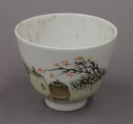 A Chinese porcelain tea bowl decorated with figures. 6 cm high.