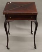 A Victorian mahogany envelope card table. 56 cm square.