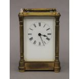 A Victorian gilded brass and enamelled dial eight-day carriage clock, with key. 16.5 cm high.