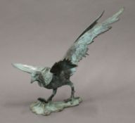 A patinated white metal model of a phoenix. 38 cm long.
