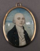 A Georgian miniature portrait on ivory depicting a young gentleman, set in an unmarked gold frame,