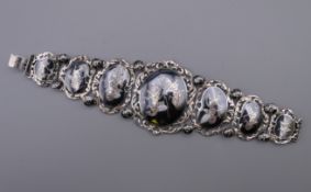 A Siam sterling silver and niello bracelet finely worked in seven hinged sections. 17.5 cm long.