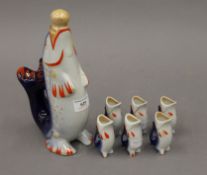 A vintage Russian fish decanter and six shot cups formed as fish. The former 25.5 cm high.