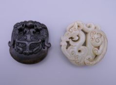 Two Chinese carved roundels. The largest 5.5 cm diameter.