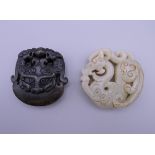 Two Chinese carved roundels. The largest 5.5 cm diameter.