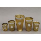 Five silver mounted horn beakers. The largest 12.5 cm high.