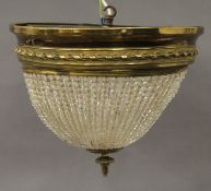 An Edwardian brass and glass bead chandelier. Approximately 30 cm high.