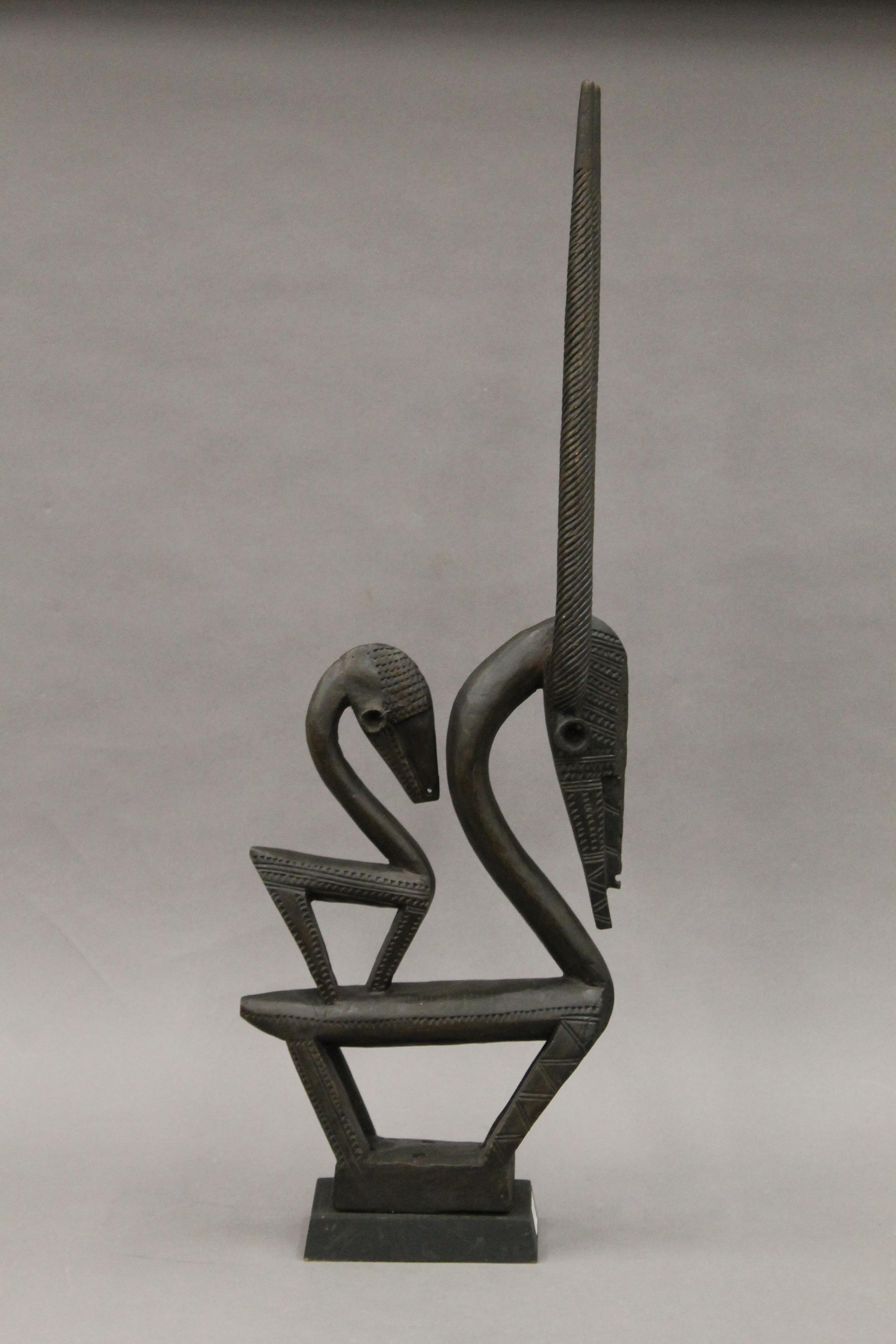 A Chiware double antelope headdress mounted on a plinth base. 81 cm high.