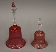 Two cranberry glass bells. The largest 28.5 cm high.