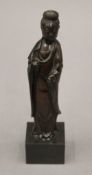 A small bronze model of Guanyin. 18 cm high.