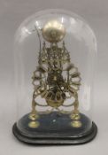 A Victorian brass skeleton clock under a glass dome. 42.5 cm high overall.