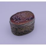 An Asian/Persian seal topped box. 3 cm wide.