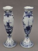 A pair of Delft blue and white vases. 31 cm high.