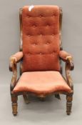 A Victorian mahogany framed open arm chair. 63 cm wide.