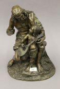 A bronze model of a fisherman and a child playing a mandolin. 39 cm high.