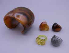 A vintage Lucite bangle and rings. The former 5.75 cm wide.