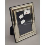A sterling silver photograph frame, hallmarked for Sheffield 1995. 18 cm high.