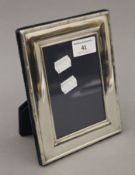 A sterling silver photograph frame, hallmarked for Sheffield 1995. 18 cm high.