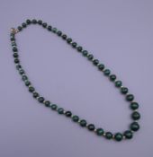 A vintage graduated malachite set of beads. Approximately 60 cm long.