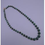 A vintage graduated malachite set of beads. Approximately 60 cm long.