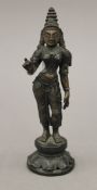 A small Indian bronze model of a deity. 16 cm high.