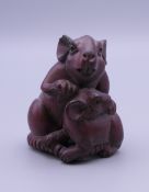 A wooden netsuke formed as a rat. 4.5 cm high.