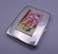 A silver cigarette case depicting nudes. 6 cm wide.