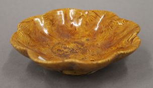 A Chinese yellow pottery dish. 11 cm diameter.