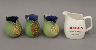 Three Royal Doulton Greene King jugs and a Bells jug. The latter 14 cm high.