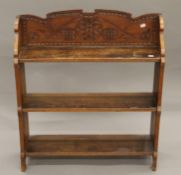 A 19th century carved standing dwarf bookcase. 72.5 cm wide.