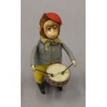 A Schuco clockwork monkey. 11 cm high.