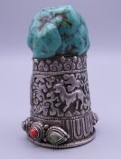 A Tibetan silver and turquoise seal. 8 cm high.