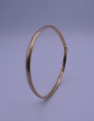 A 9 ct gold bangle form bracelet. 7 cm wide. 5.7 grammes.