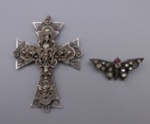 A Chester silver and paste butterfly brooch and a French unmarked white metal cross form pendant.