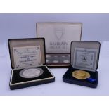 Two boxed Commemorative coins and a boxed Bahrain proof set.