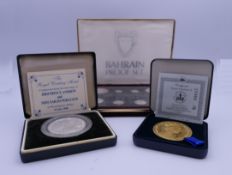 Two boxed Commemorative coins and a boxed Bahrain proof set.