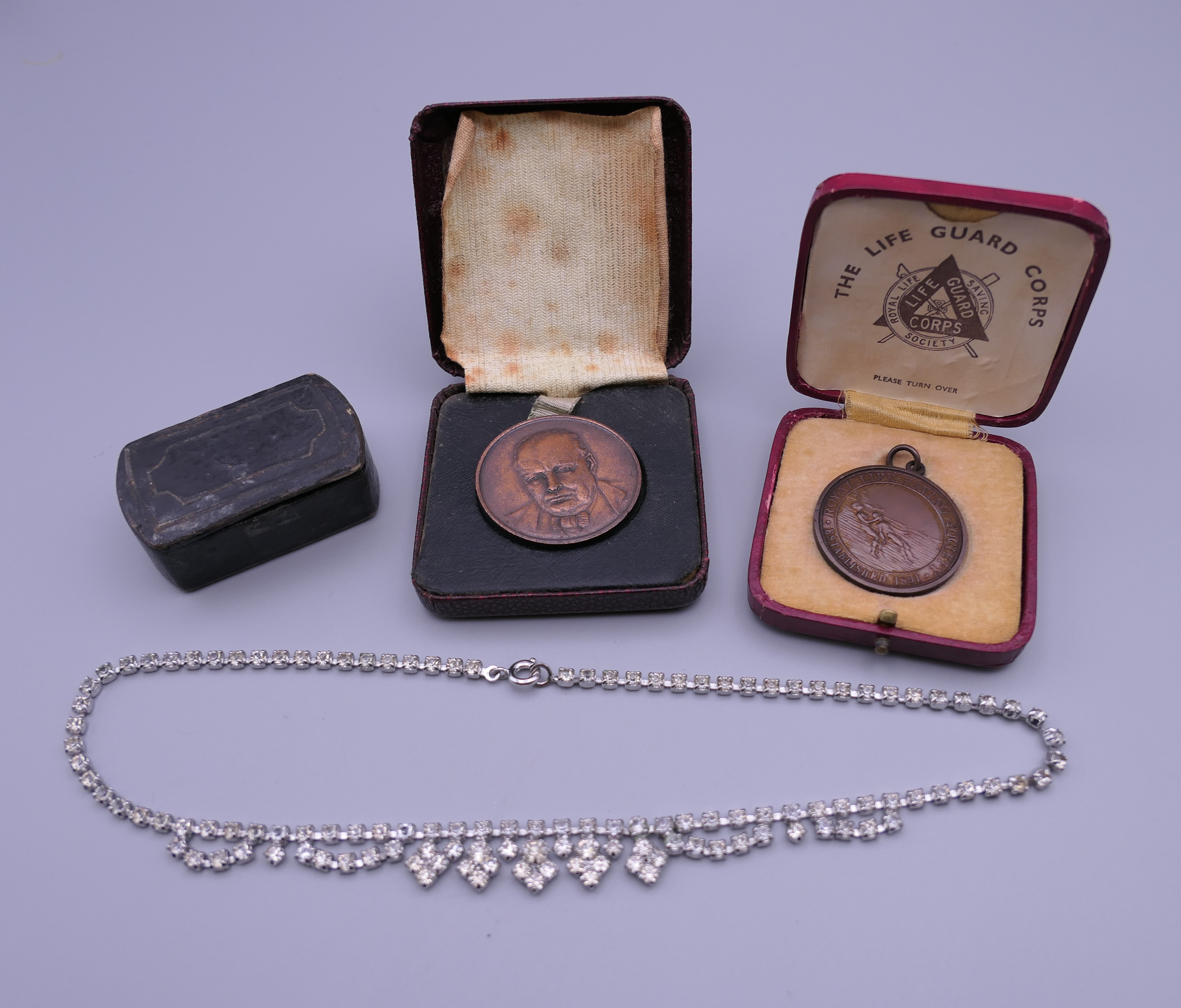 A Winston Churchill medallion, another medallion, a snuff box and a ...