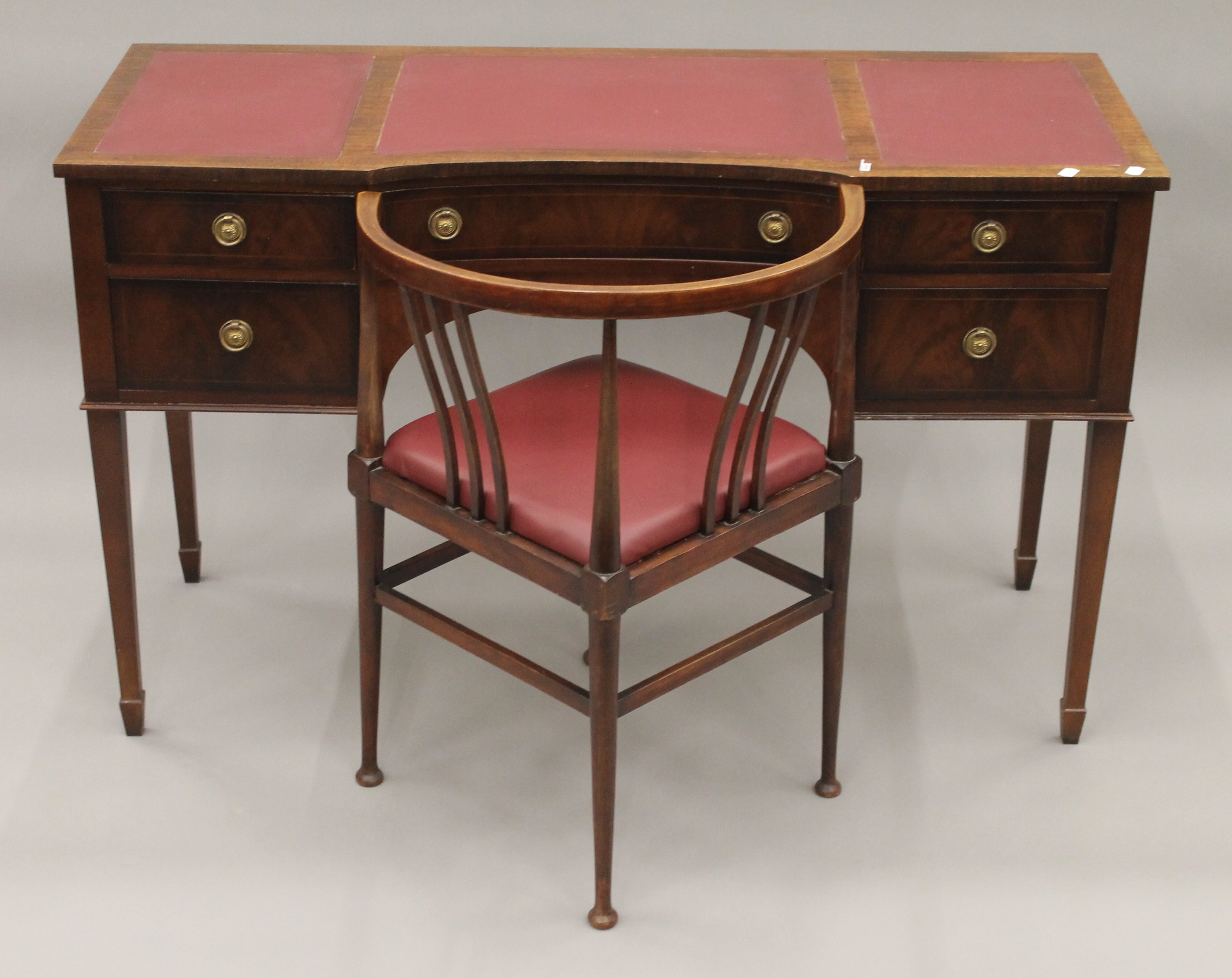 A reproduction mahogany desk and a corner chair. The former 122 cm wide.