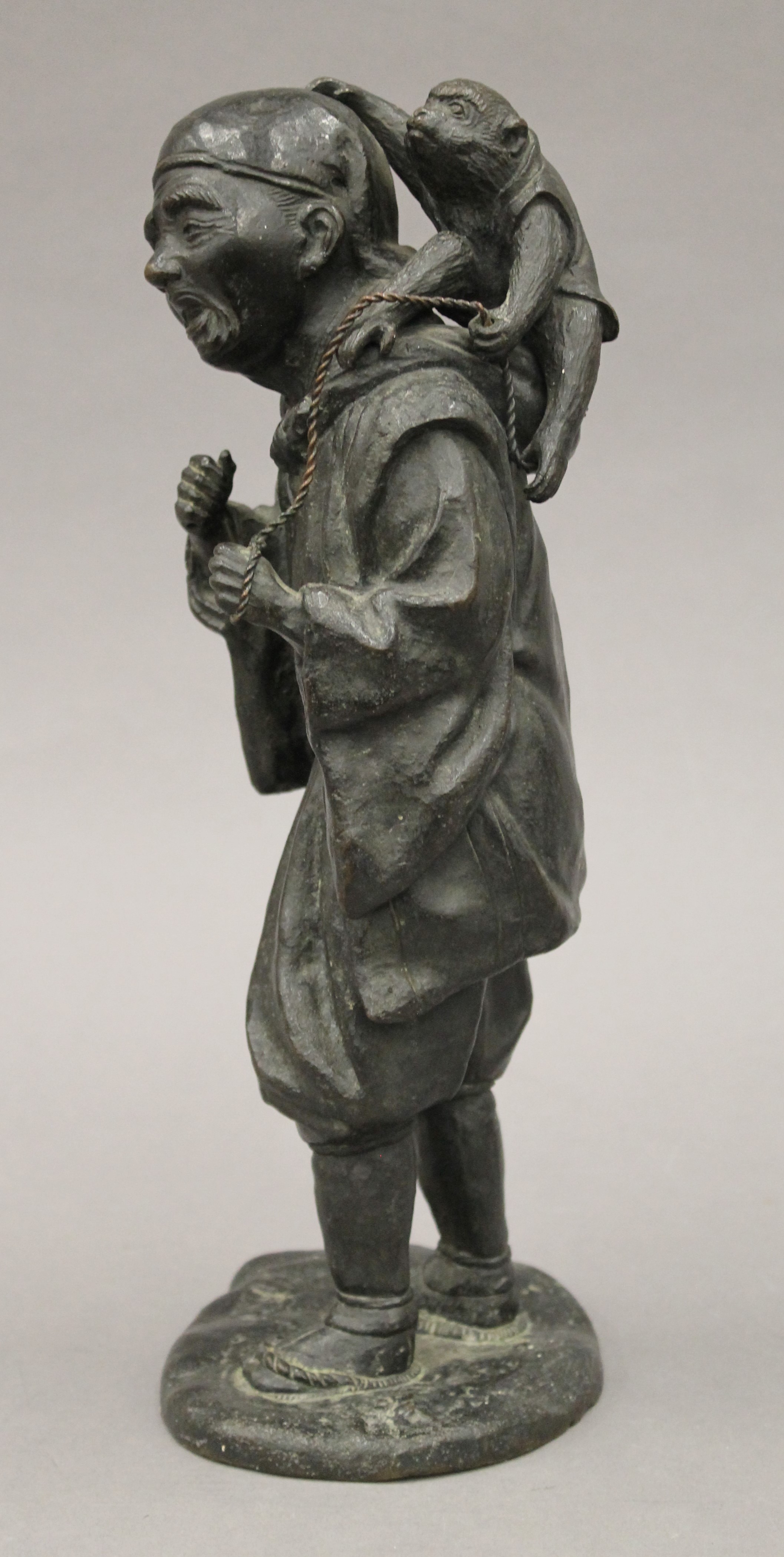 A Japanese Meiji period bronze model of a man with a monkey. 32 cm high. - Image 4 of 7