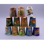 Twelve cloisonne thimbles.