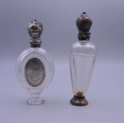 Two Continental silver topped scent bottles. The largest 10.5 cm high.