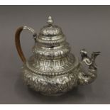 An embossed Dutch silver teapot, possibly Dutch Colonial. 16.5 cm high. 18.