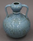 A Chinese porcelain pale blue vase with handles. 22 cm high.