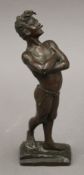 A patinated bronze model of a boy smoking. 21 cm high.