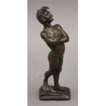 A patinated bronze model of a boy smoking. 21 cm high.