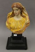 An antique polychrome decorated carved wooden bust of a woman,