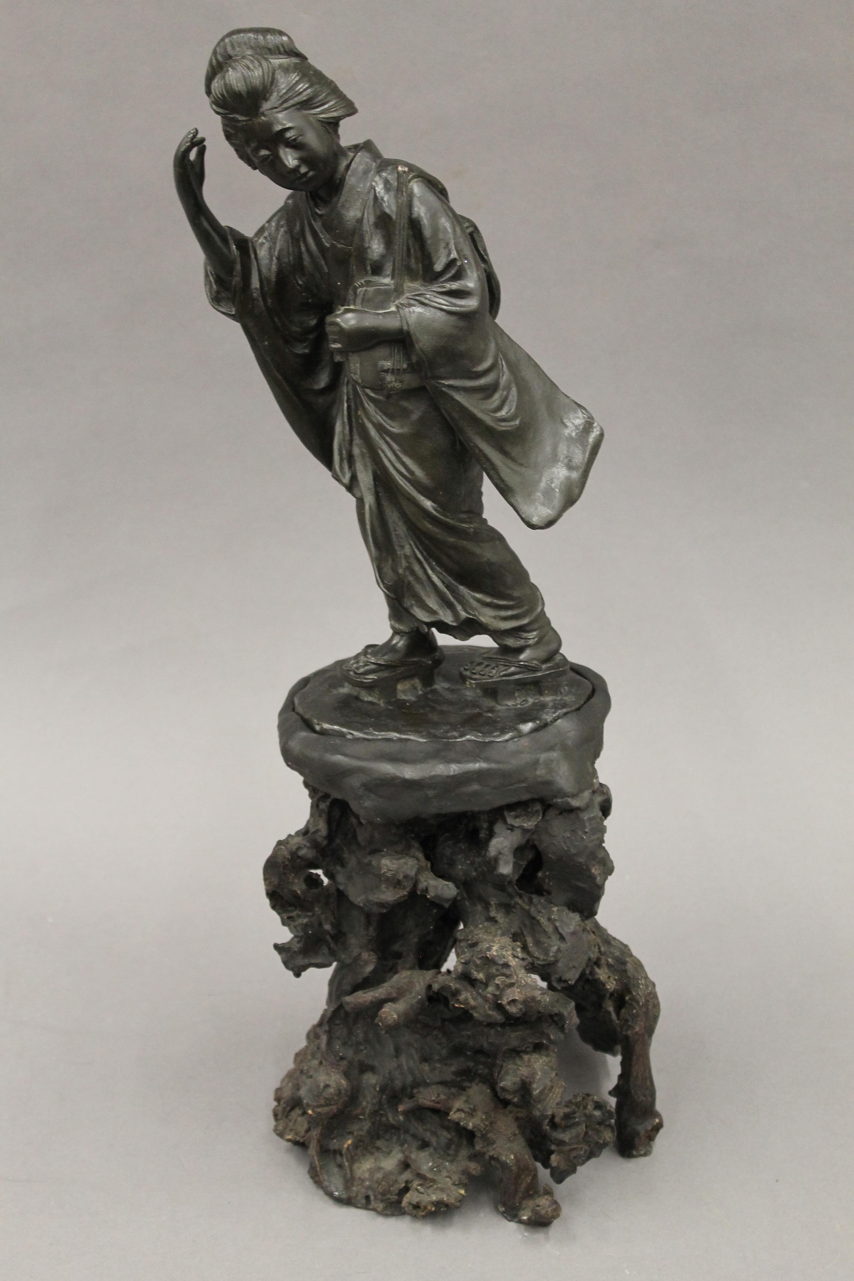 A Japanese Meiji period bronze model of a geisha, 32 cm high.