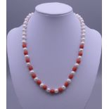 A pearl and coral necklace with a 14 ct gold clasp. 41 cm long.